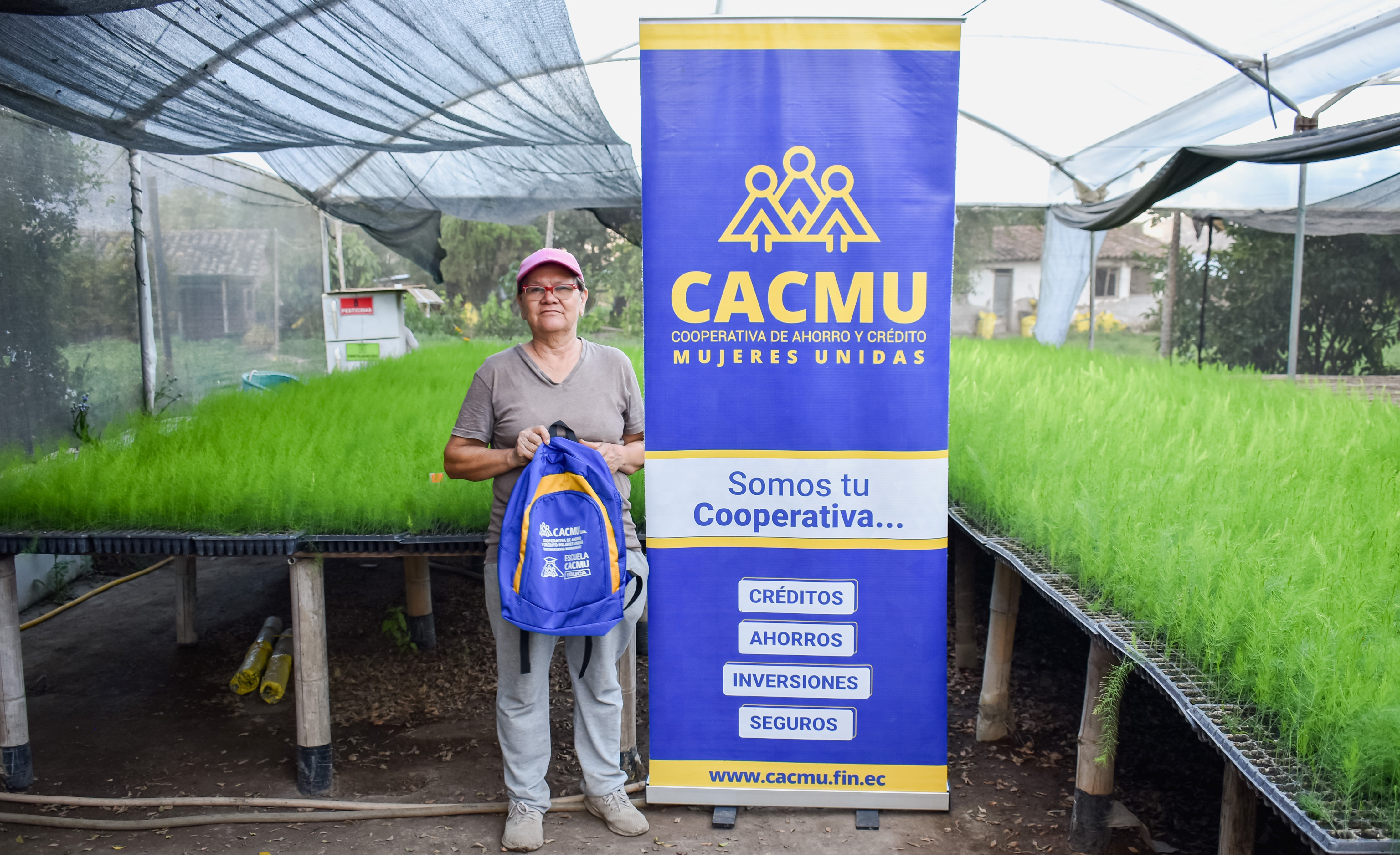 woman stands next to CACMU banner